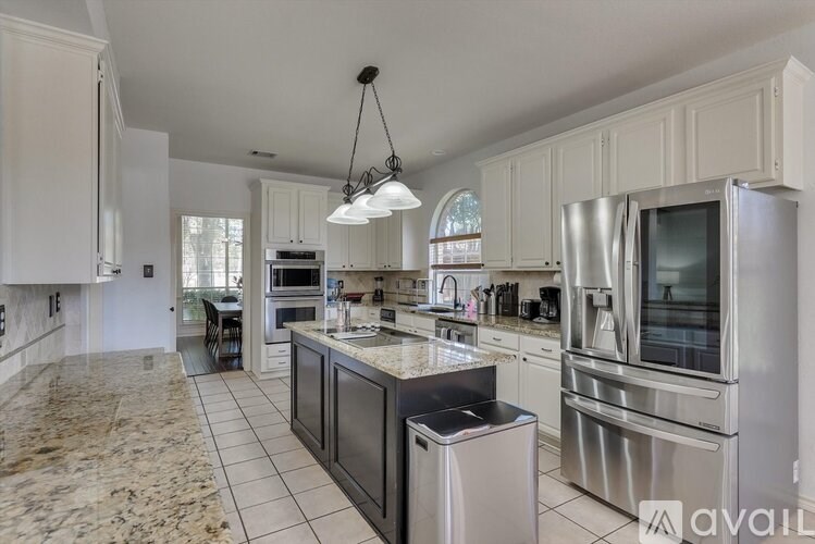 A kitchen with granite countertops and stainless steel appliances.