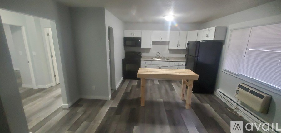 A kitchen with a table and chairs in the middle of the room.