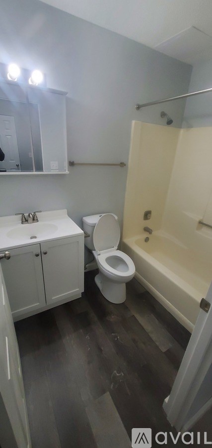A bathroom with a toilet, sink, and bathtub.