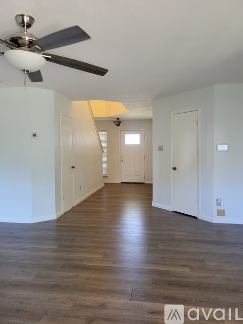 A long hallway with a fan and light fixture.
