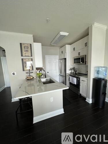 A kitchen with a marble island in the middle.