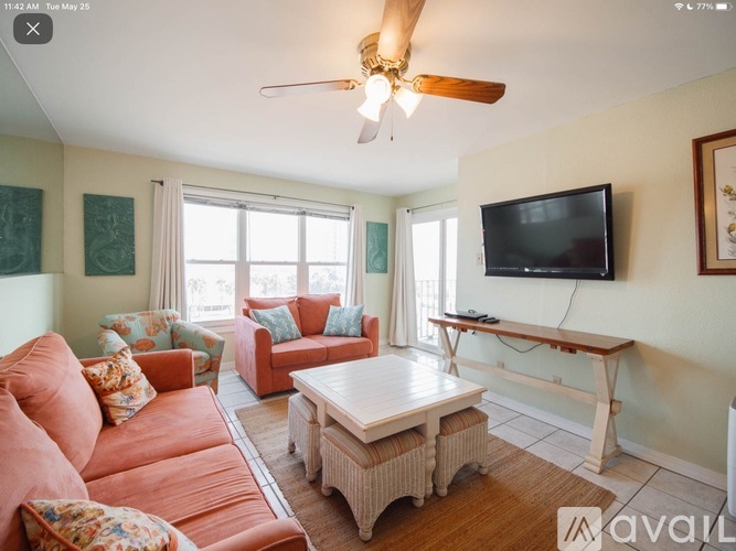 A living room with a television, two couches, and a coffee table.