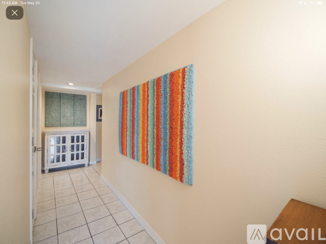 A room with a striped tapestry hanging on the wall.