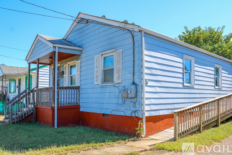 A blue and white mobile home with a porch.