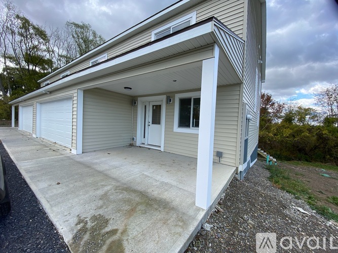 A two-story house with a garage on the side.