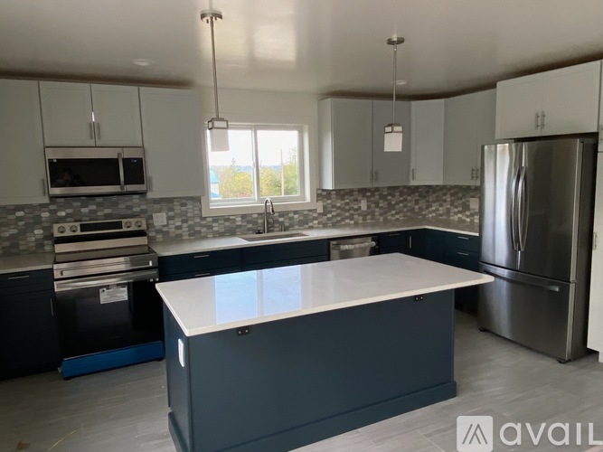 A kitchen with a large island in the middle.