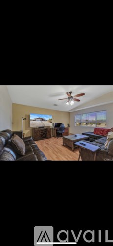 A living room with a couch and a television.