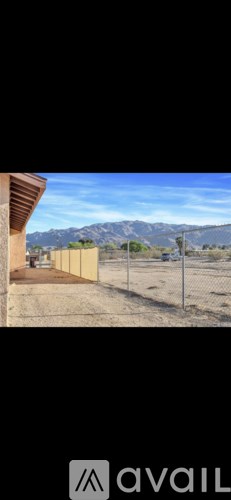 A construction site with a fence and a building under construction.