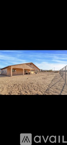A house is available for sale in a desert-like area.