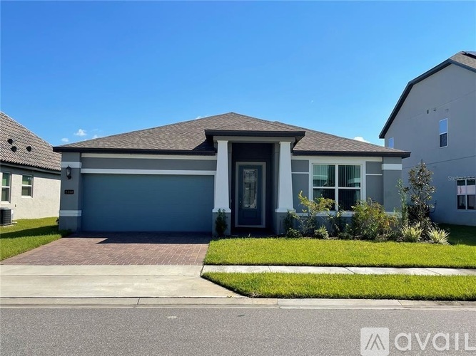 A house with a grey garage door is for sale.