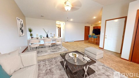 A living room with a glass coffee table and a sofa.