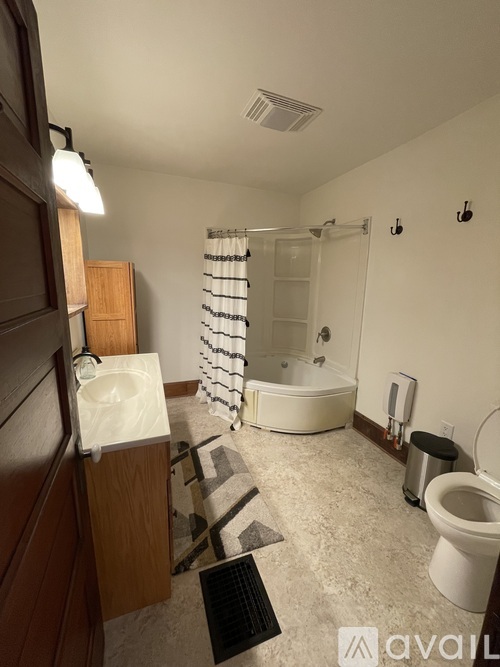 A bathroom with a toilet, sink, and bathtub.