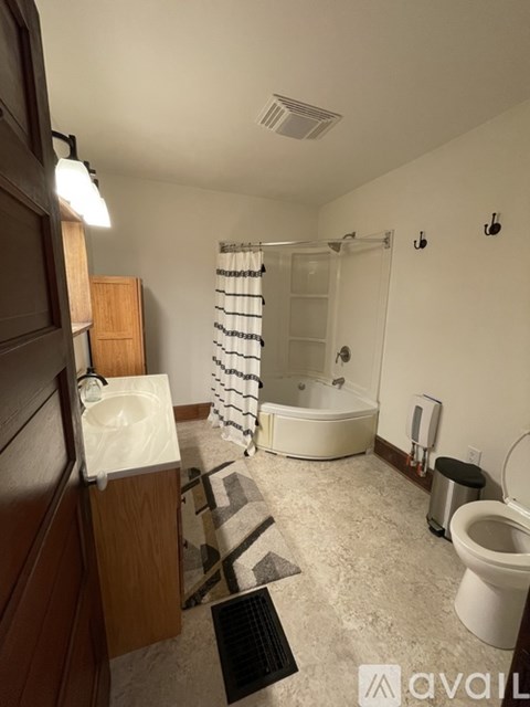 A bathroom with a toilet, sink, and bathtub.
