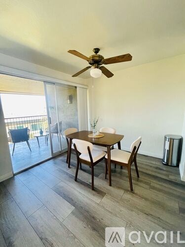A dining room with a table set for four.