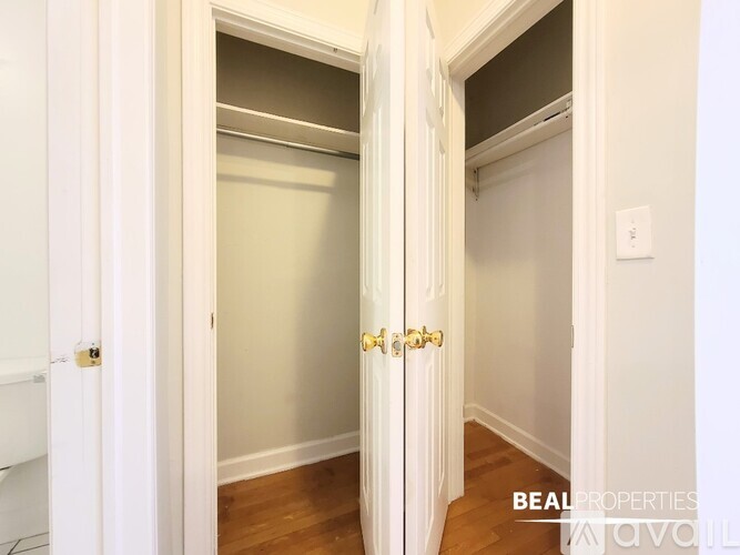 A room with a ceiling fan and wooden flooring.