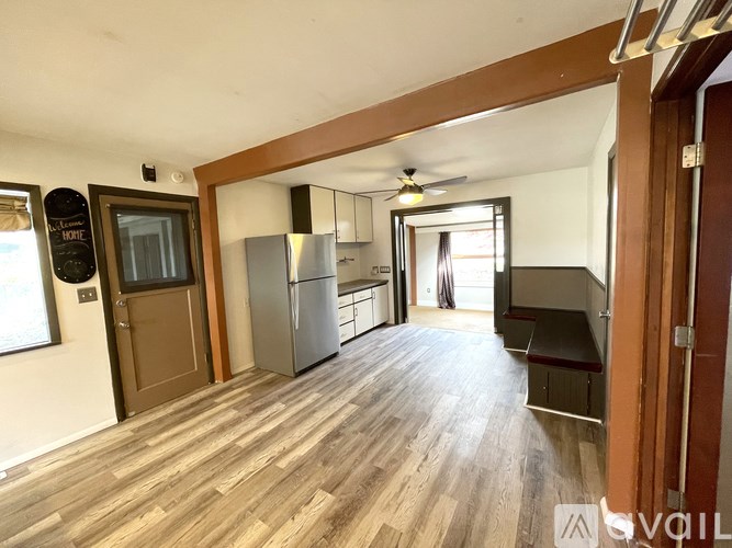 A kitchen with a refrigerator, a stove, and a countertop.