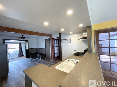 A kitchen with a sink and a refrigerator.