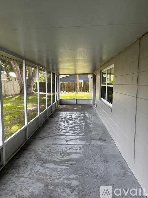A long, narrow hallway with a tiled floor and white walls.