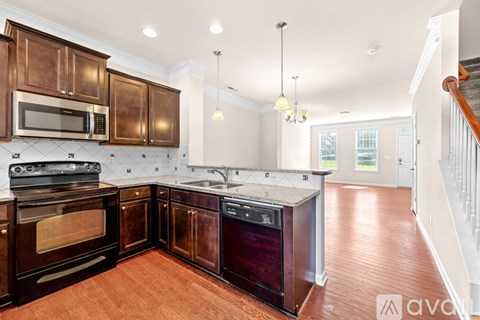 A kitchen with wooden cabinets and a stove top oven.