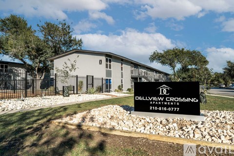 A sign for Delview Crossing Apartments is in front of a building.