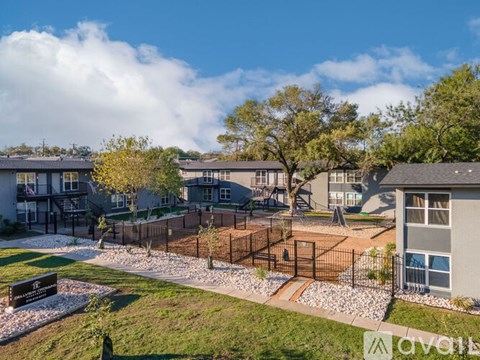 A sunny day at a residential area with houses and a playground.