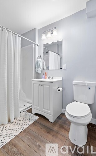 A white toilet sits next to a sink in a bathroom.
