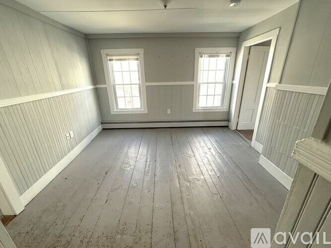 A room with wooden floors and white walls.