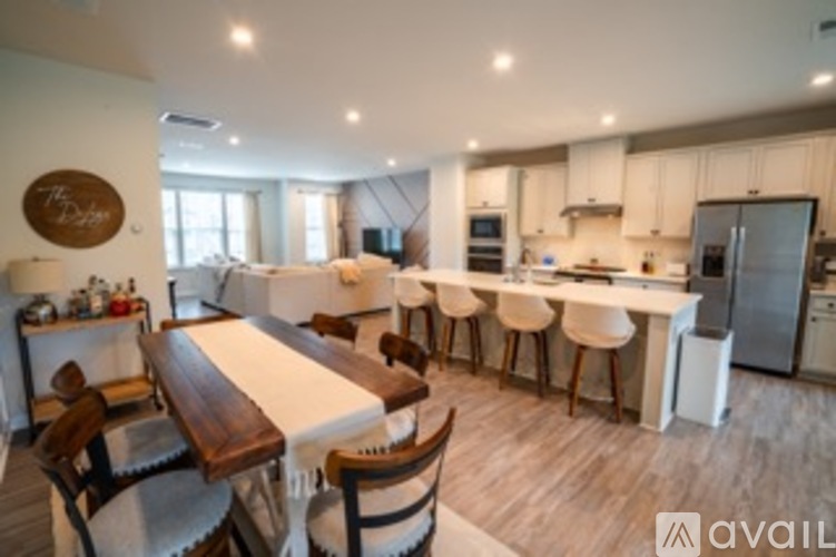 A modern kitchen with a dining table and chairs.