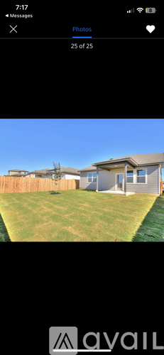 A house with a fence and a green lawn.