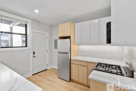 A kitchen with a stove top oven sitting under a window.