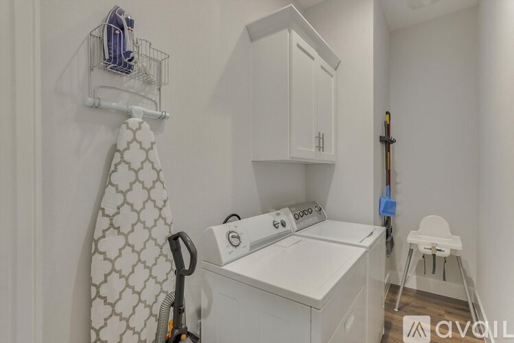 A white laundry room with a washer and dryer.