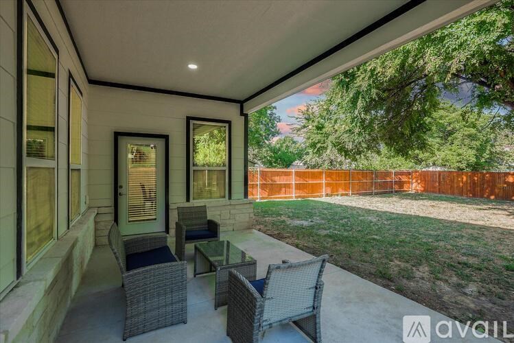A patio with a table and chairs is shown.
