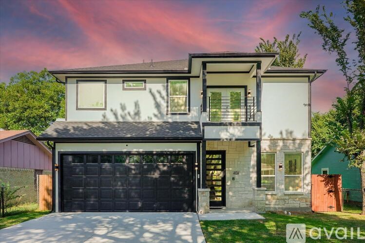 A modern two-story house with a garage is available for sale.