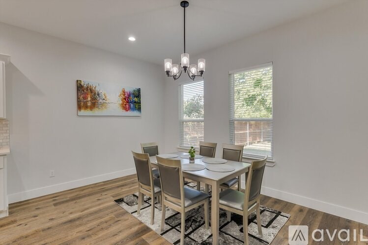 A dining room with a wooden table and chairs.