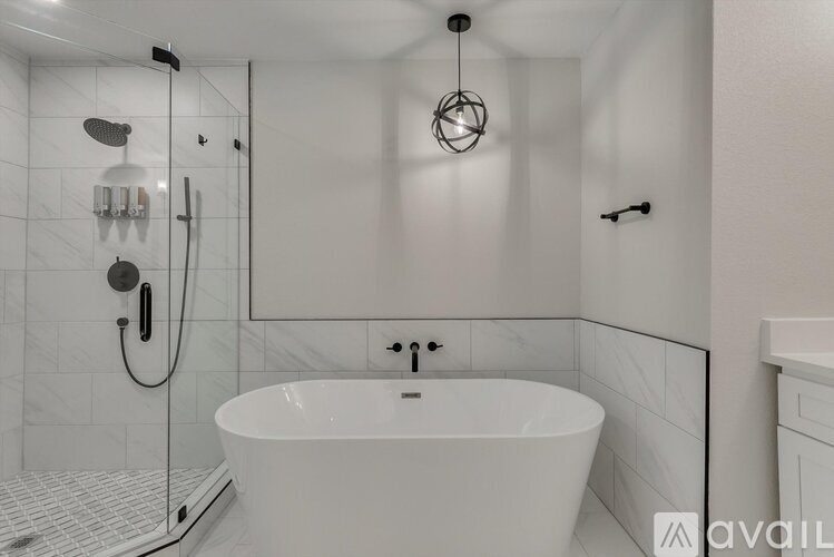 A white bathroom with a tub and shower.
