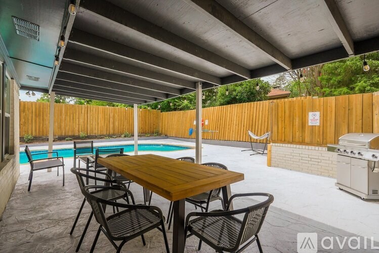 A patio with a table and chairs is available for rent.