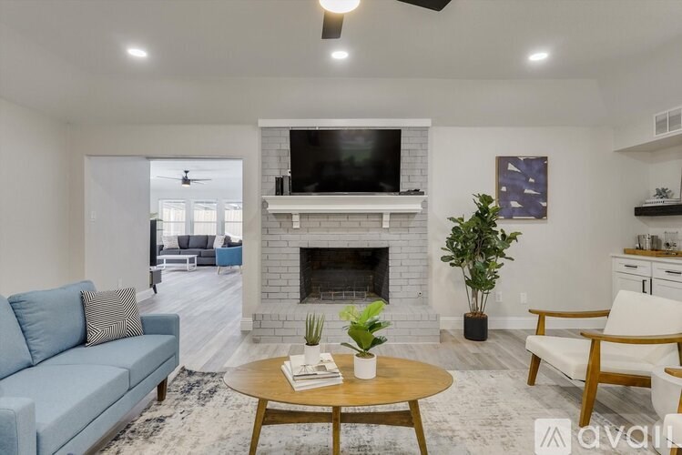 A living room with a fireplace and a television.