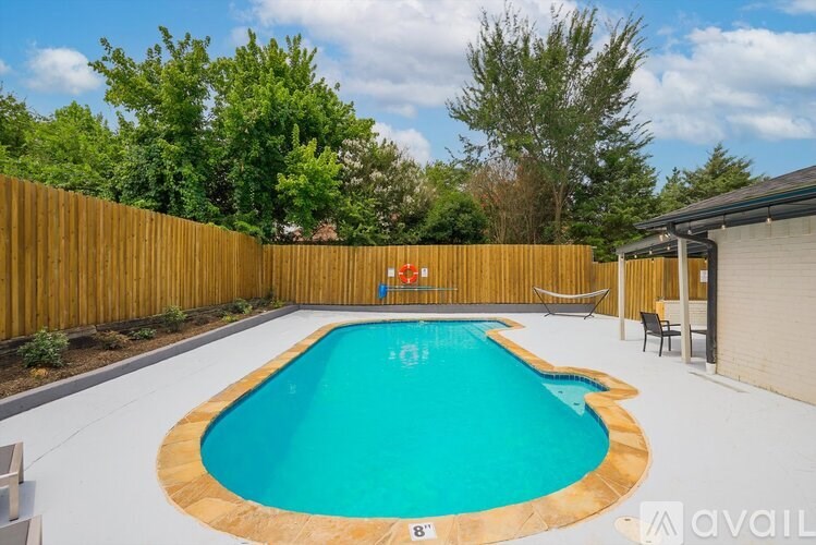 A small kid's pool in a backyard.