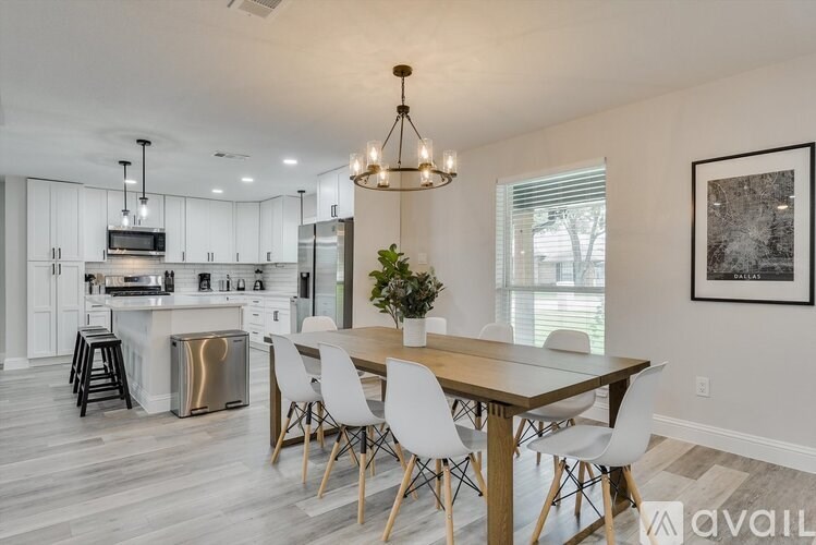 A modern kitchen with a dining table and chairs.
