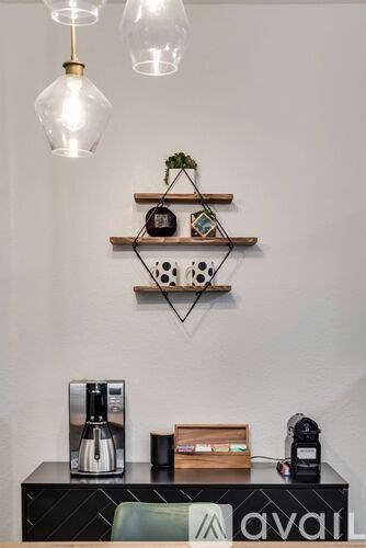 A black shelf with a plant, a clock, and a small box on it.
