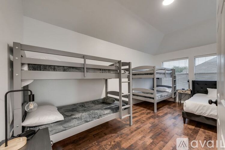 A room with bunk beds and a single bed.