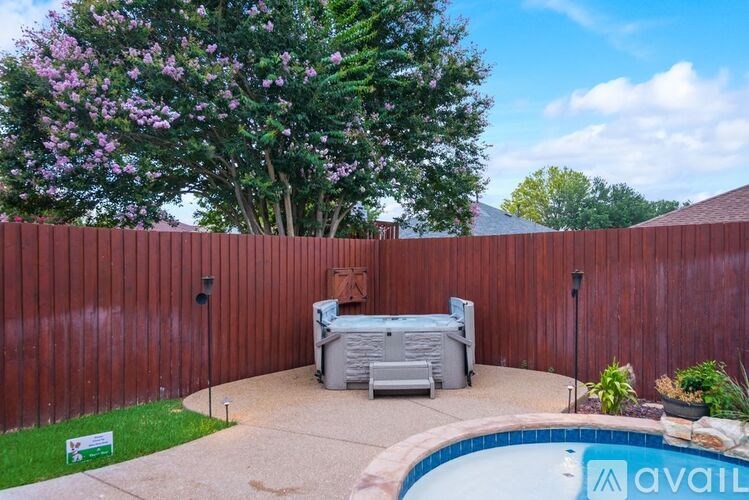 A backyard with a pool and a hot tub.