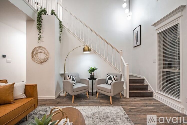 A living room with a staircase and a couch.