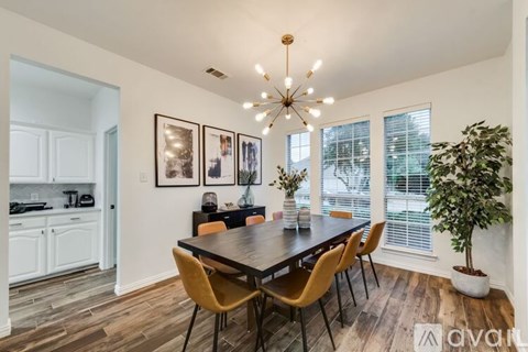 A dining room with a wooden table and chairs.