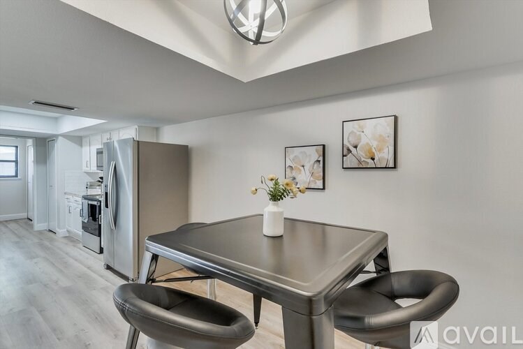 A modern kitchen with a table and chairs.