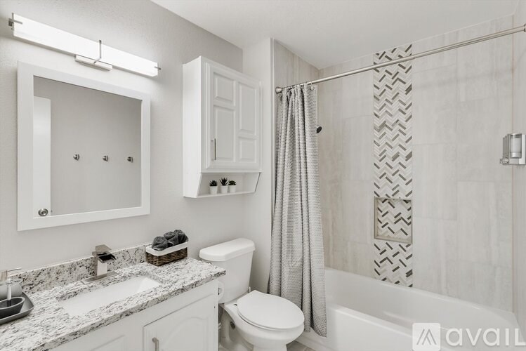 A bathroom with a toilet, sink, and shower.