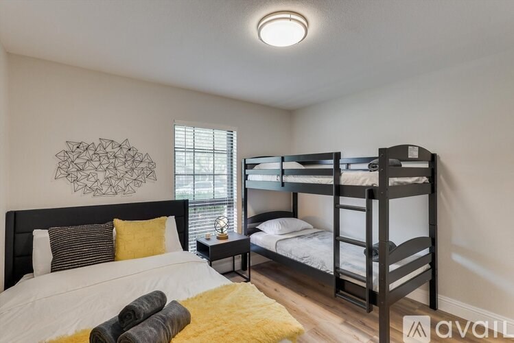 A bedroom with a bunk bed and a single bed.