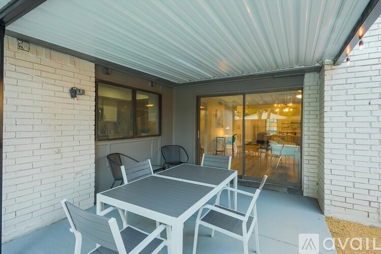 A patio with a table and chairs is available for rent.