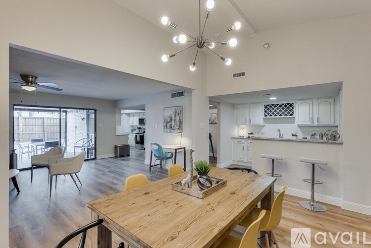 A modern dining room with a wooden table and chairs.