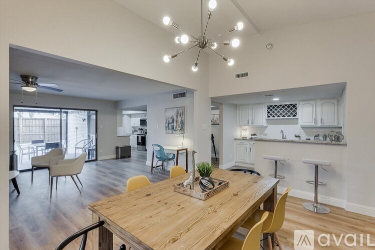 A modern dining room with a wooden table and chairs.